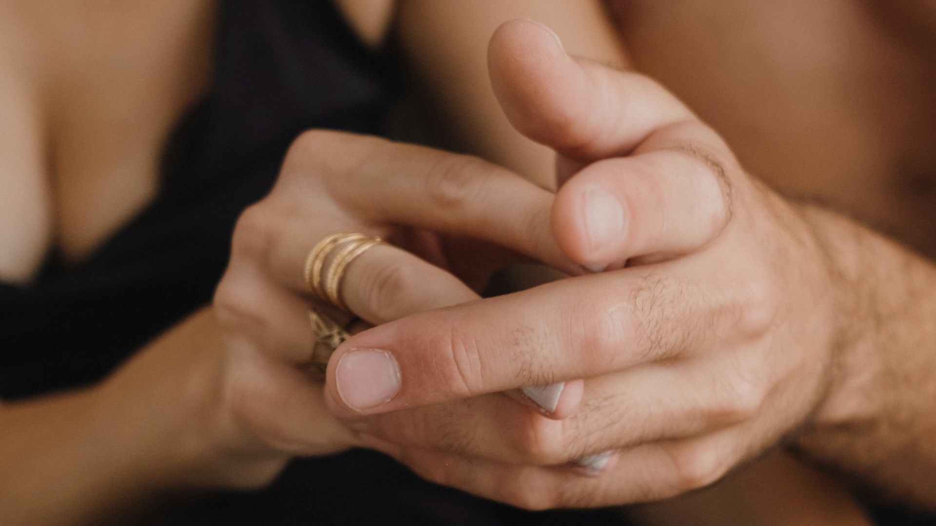 Couple holding hands intimately, symbolising connection and communication in relationships